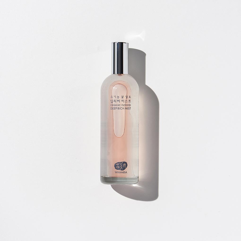 Whamisa Organic Flowers Deep Rich Mist bottled in a clear cylindrical bottle with a cap that can be easily taken off. The content is mostly clear with a layer of red pinkish oil that enriches the mist.